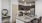 Spacious and well lit kitchen with wood floors and stainless steel appliances 